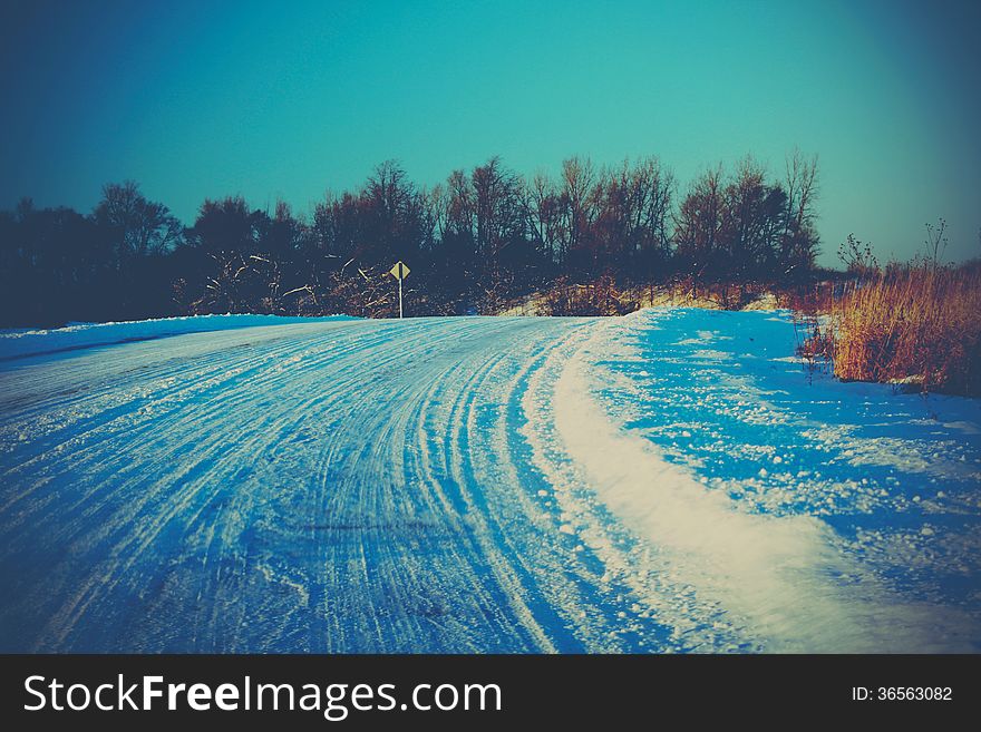 Winter road with snow and blue sky