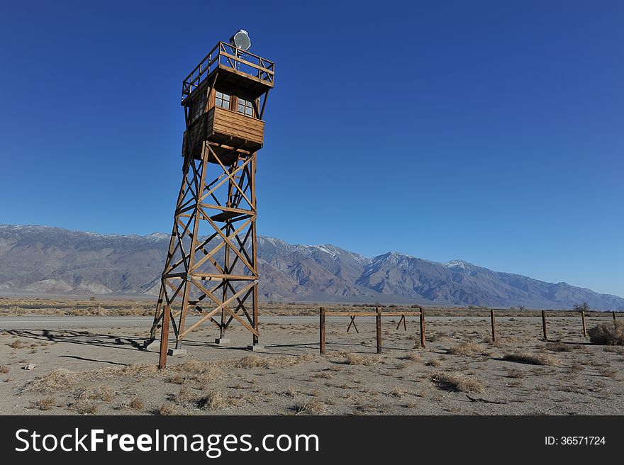 Wooden guard tower in desert by mountains