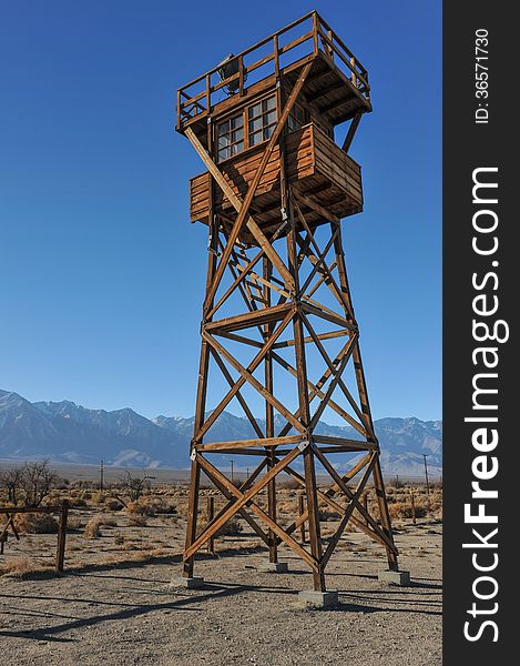 Guard tower with a search light in the desert by the mountains. Guard tower with a search light in the desert by the mountains