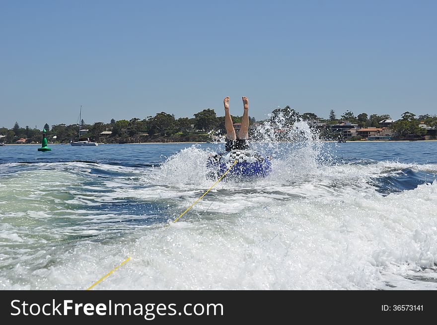 Male teen water skiing tubing in the swan river perth. Male teen water skiing tubing in the swan river perth