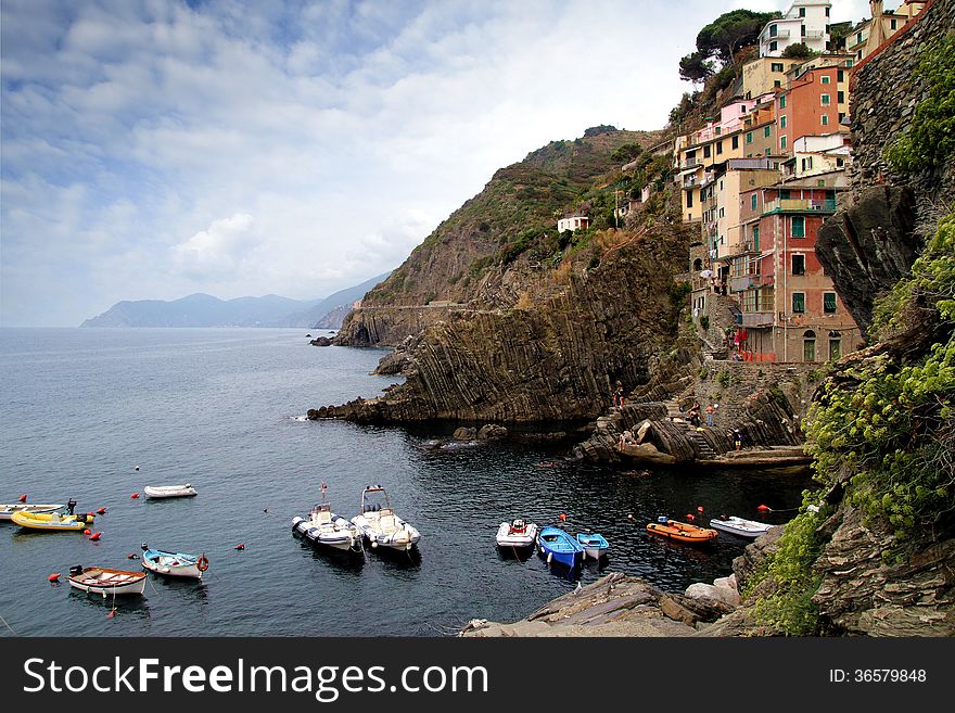 Cliff and colored houses of Riomaggiore in Italy. Cliff and colored houses of Riomaggiore in Italy