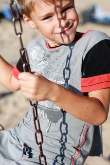 Smiling Boy On The Swing Royalty Free Stock Photos