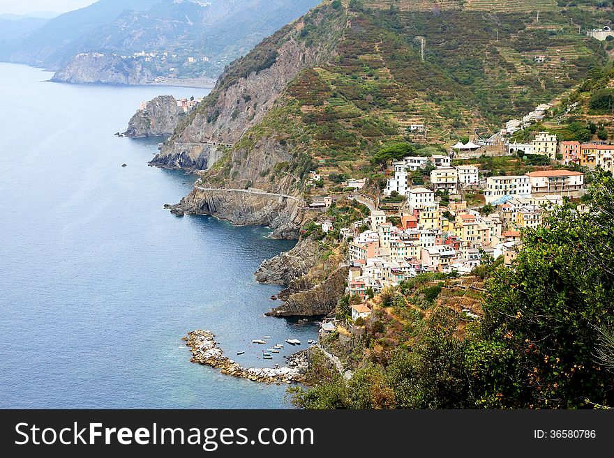 Cliff and colored houses of Riomaggiore in Italy. Cliff and colored houses of Riomaggiore in Italy