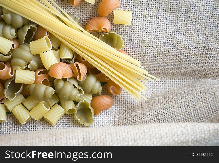 Uncooked pasta on natural fabric