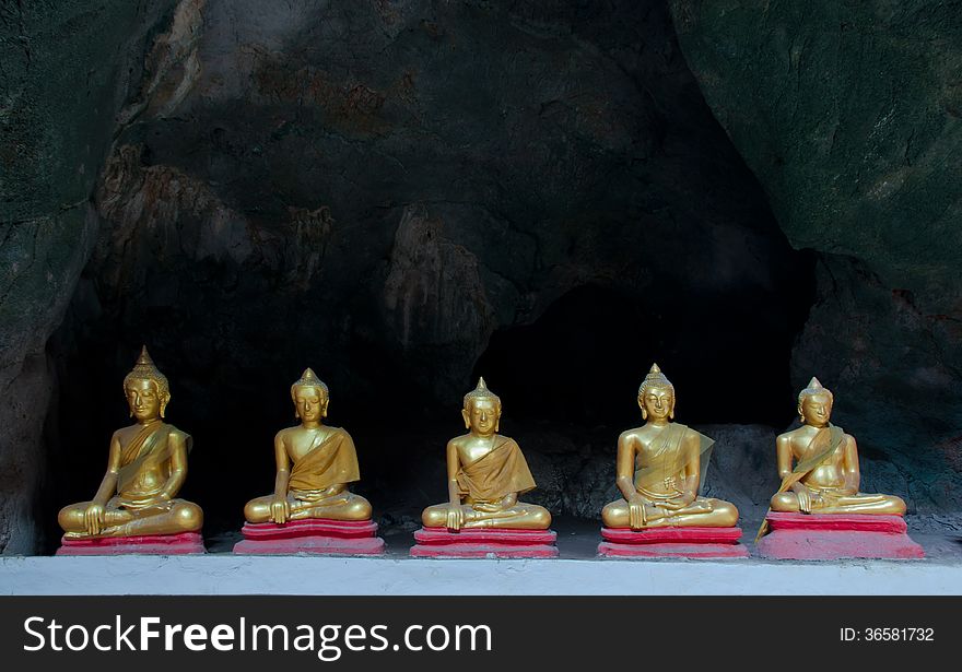 Five Sitting Golden Buddha in the caveg at Khao Luang Cave Temple in Petchaburi, Thailand. Five Sitting Golden Buddha in the caveg at Khao Luang Cave Temple in Petchaburi, Thailand