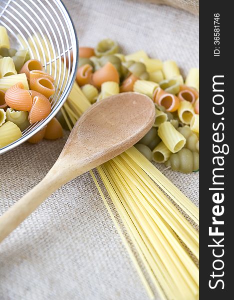 Wooden spoon put on uncooked pasta