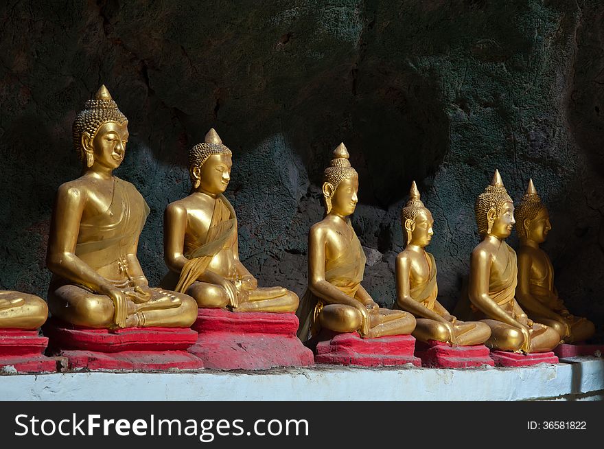 Six Sitting Golden Buddha in the caveg at Khao Luang Cave Temple in Petchaburi, Thailand. Six Sitting Golden Buddha in the caveg at Khao Luang Cave Temple in Petchaburi, Thailand