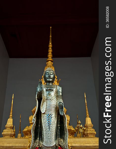 The Metal Standing Buddha With Golden Pagoda In The Temple In Th