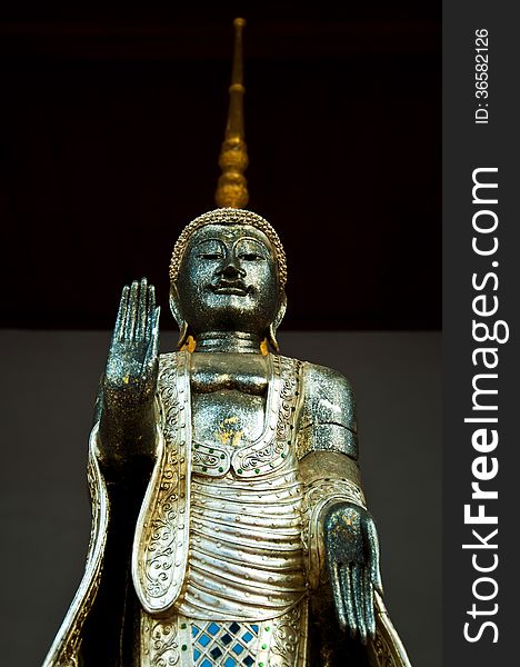 The Metal Standing Buddha With Golden Pagoda In The Temple In Th