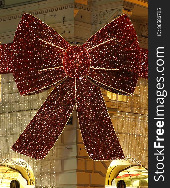 Christmas decoration over the entrance of an elegant sore in the city of vienna, austria. It shows a huge bow tie, all over covered with glittering lights. Christmas decoration over the entrance of an elegant sore in the city of vienna, austria. It shows a huge bow tie, all over covered with glittering lights