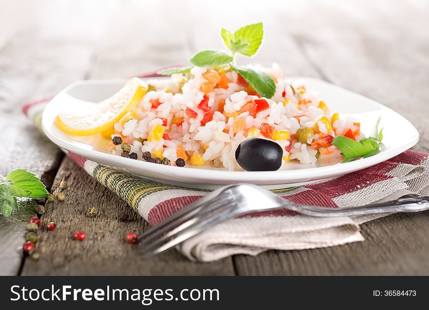 Rice with vegetables on a wooden table