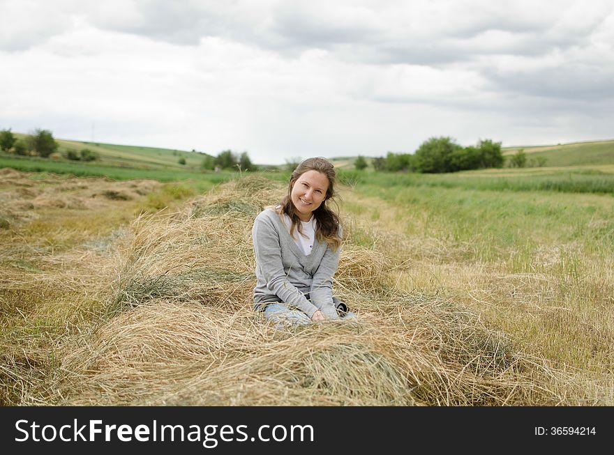 Girl In Hay  With Clouds