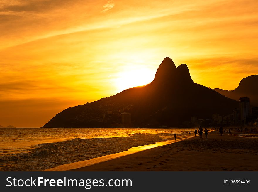 Warm Sunset On The Beach With Mountains In Horizon