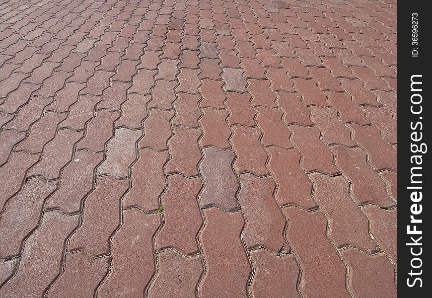 Perspective of red cobblestone floor of park in sunlight. Perspective of red cobblestone floor of park in sunlight