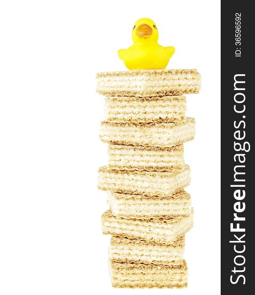 Small duck on high tower stack wafer on white background