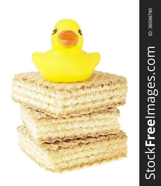 Small duck on three piece wafer stack on white background. Small duck on three piece wafer stack on white background