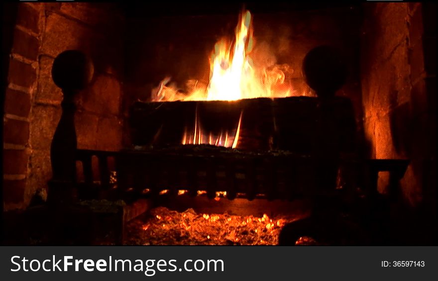 Warm, soothing fire in an old rustic fireplace. Warm, soothing fire in an old rustic fireplace.