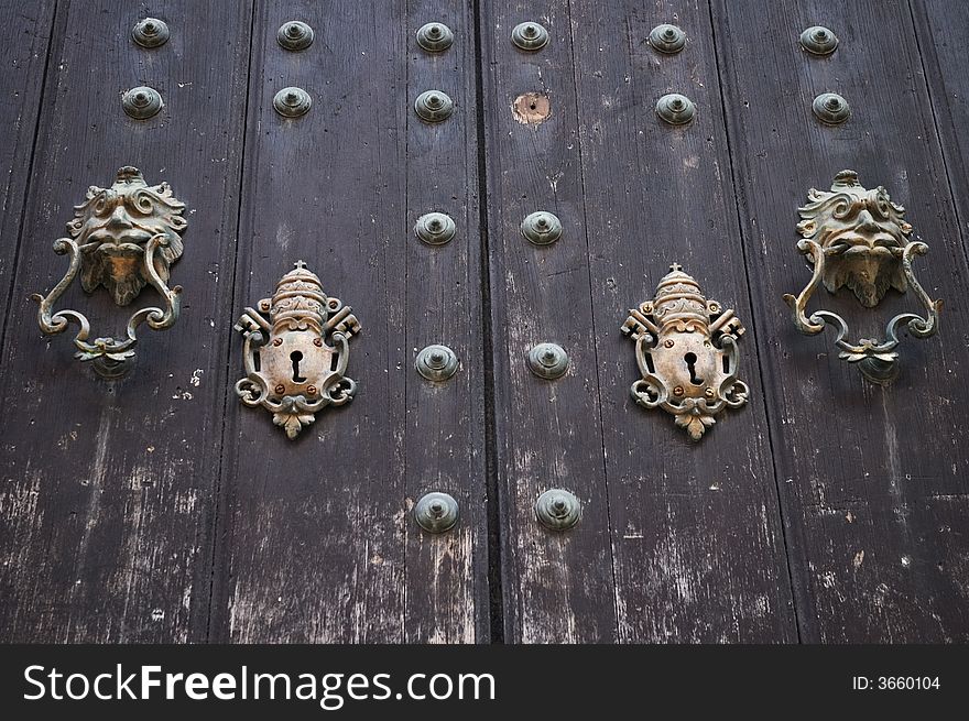 Colonial door with vintage locks and lion doorbell. Colonial door with vintage locks and lion doorbell