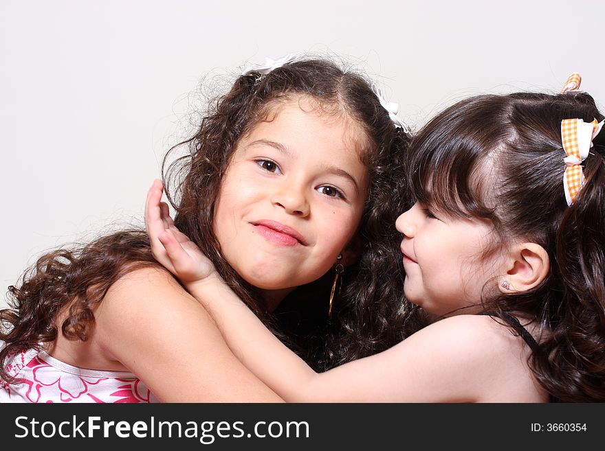 Two little girls embracing and happy. Two little girls embracing and happy