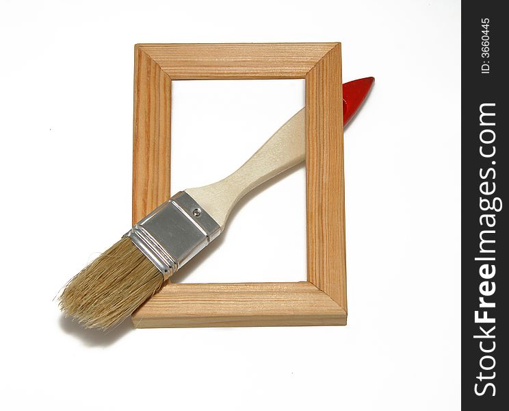 Wooden framework with a flat brush on a white background. Wooden framework with a flat brush on a white background.