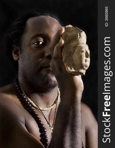 Afroamerican man holding buddha stone figurine. Afroamerican man holding buddha stone figurine