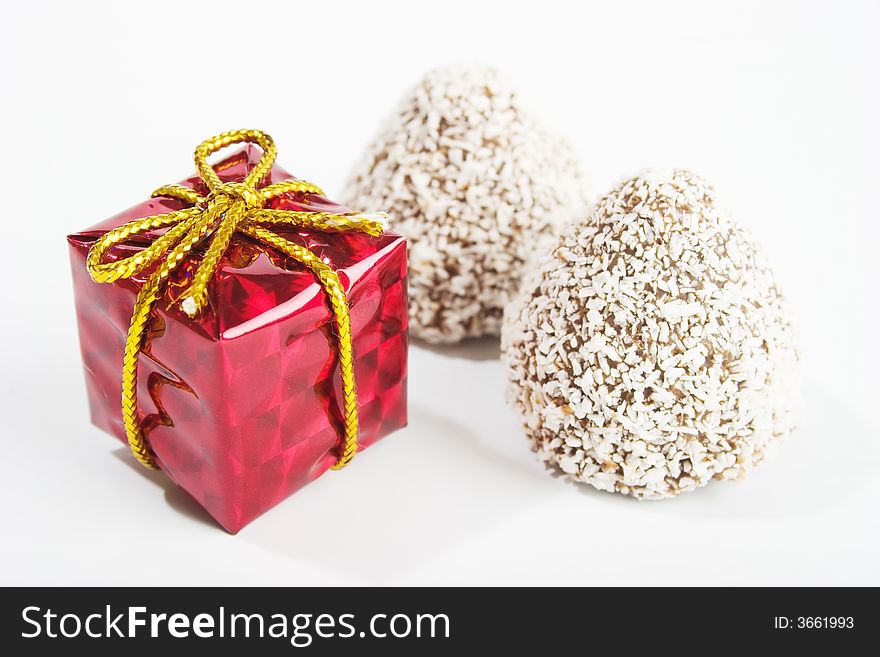 Gift and sweets on white background