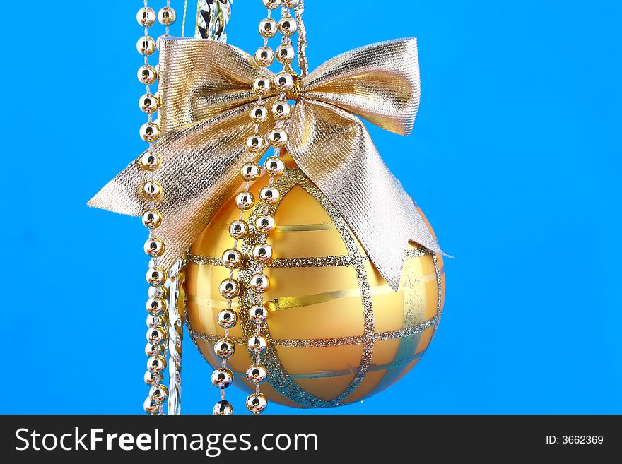 Golden decorative Christmas bauble isolated on blue backgrund. Golden decorative Christmas bauble isolated on blue backgrund