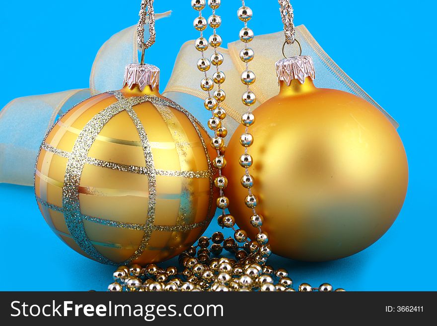 Golden decorative Christmas bauble isolated on blue backgrund. Golden decorative Christmas bauble isolated on blue backgrund