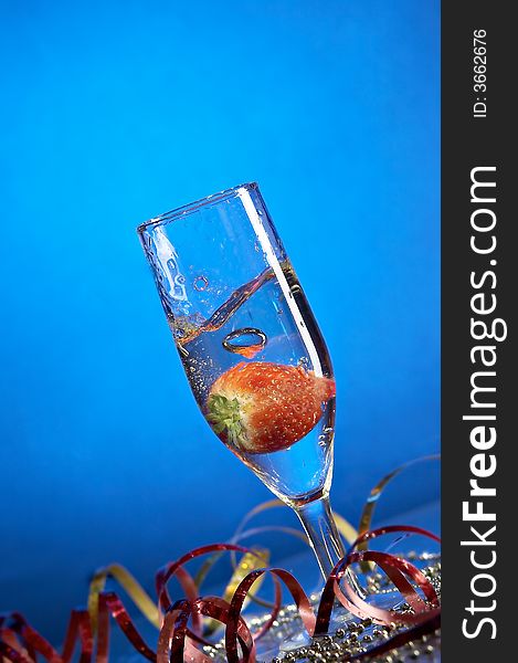 Still life with glass with champagne on the blue background