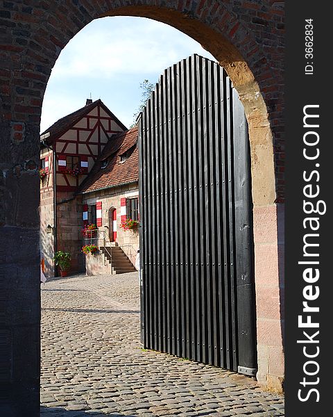 An open gate entry door to ancient buildings