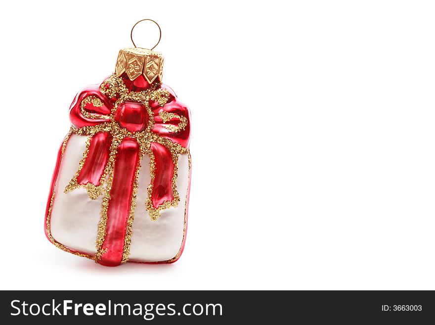 Close-up shot of pretty Christmas decoration in the form of present on white background with copy space at right. Close-up shot of pretty Christmas decoration in the form of present on white background with copy space at right