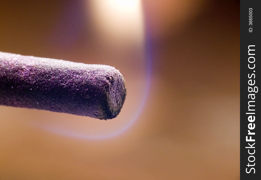 Macroshot of an incense stick just being lit. Macroshot of an incense stick just being lit