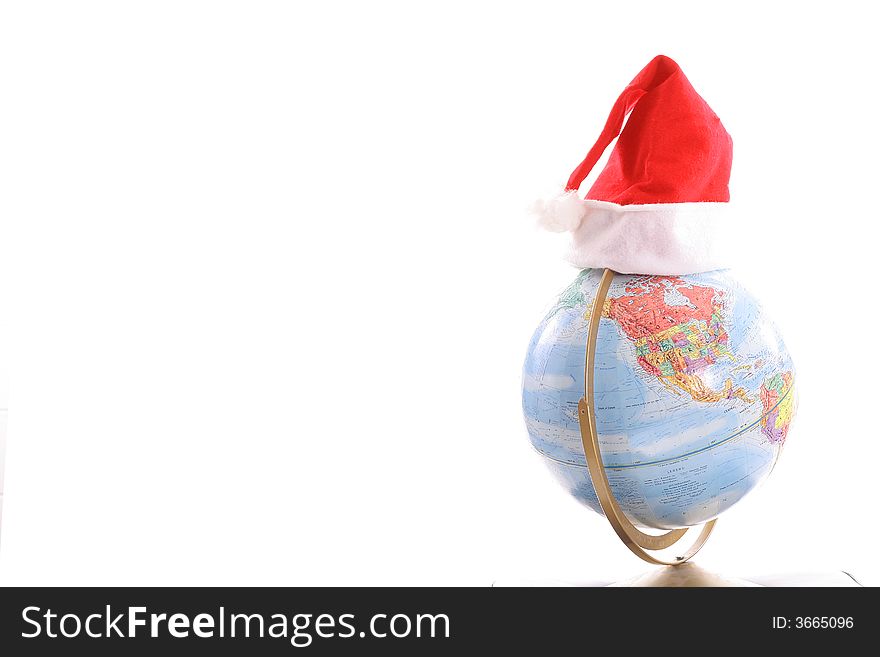 Shot of a globe with Santa hat