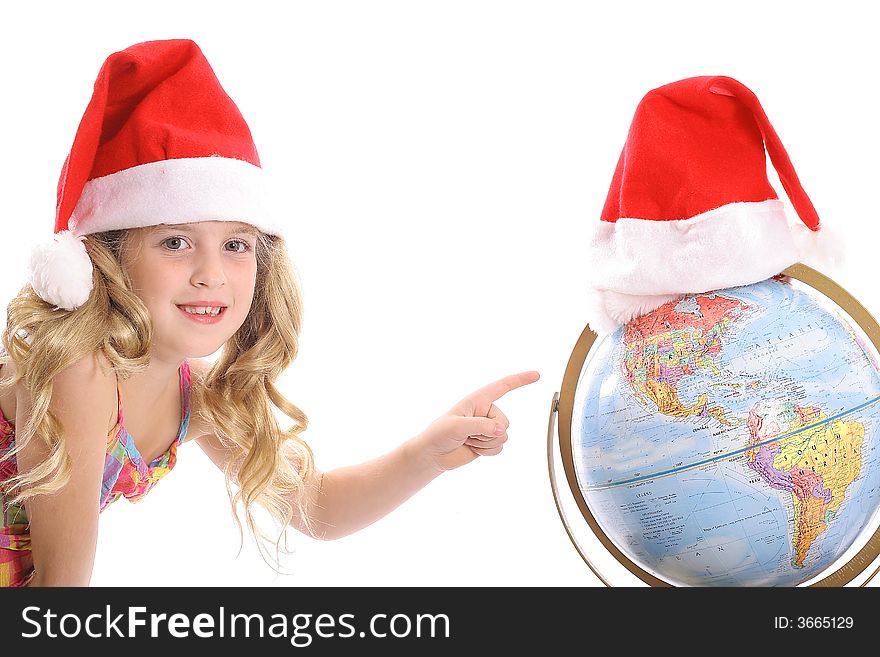 Photo of a Happy little Santa girl pointing at Globe