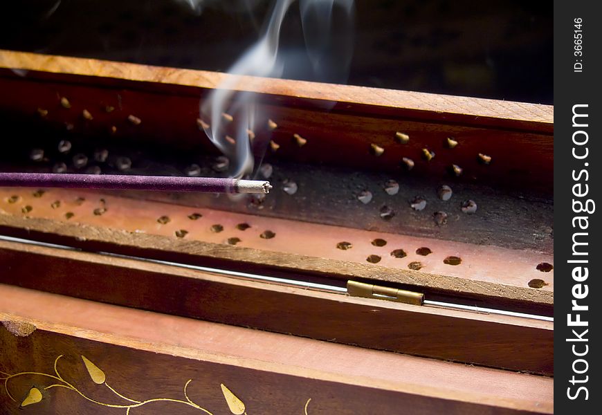 Closeup of an incense stick smoking