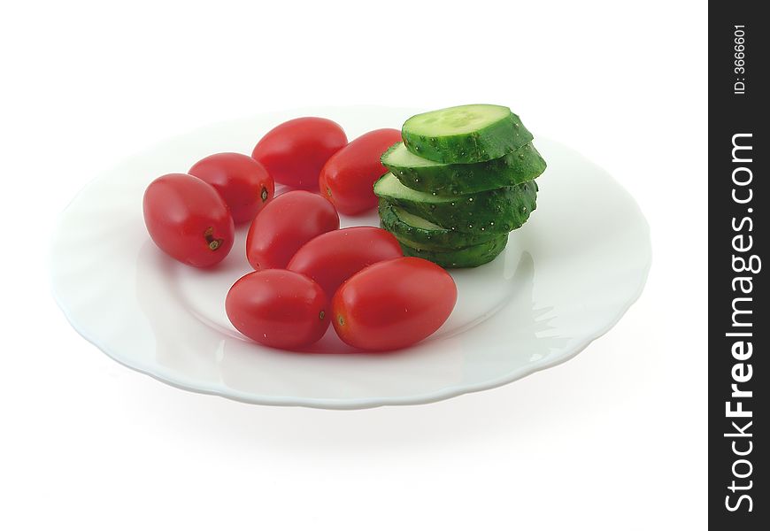 Sliced cucumber and small tomatoes, isolated on white. Sliced cucumber and small tomatoes, isolated on white.