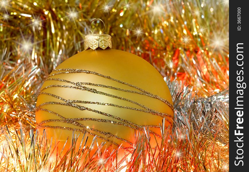 Yellow christmas decoration ball on bright background