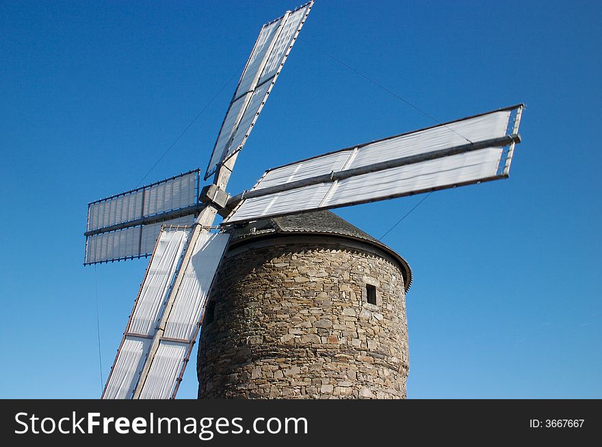 A historic stone windmill in action. A historic stone windmill in action