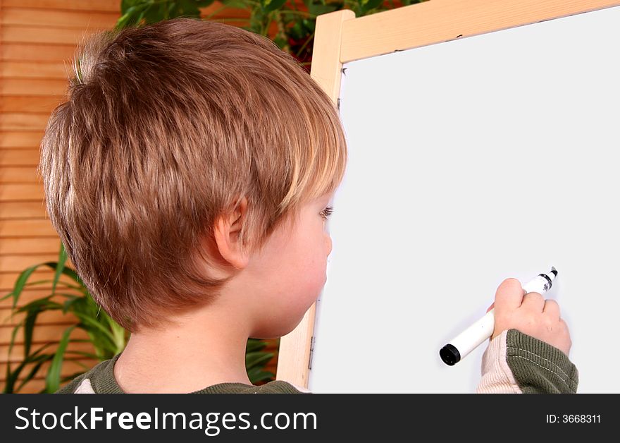The boy drawing on a board