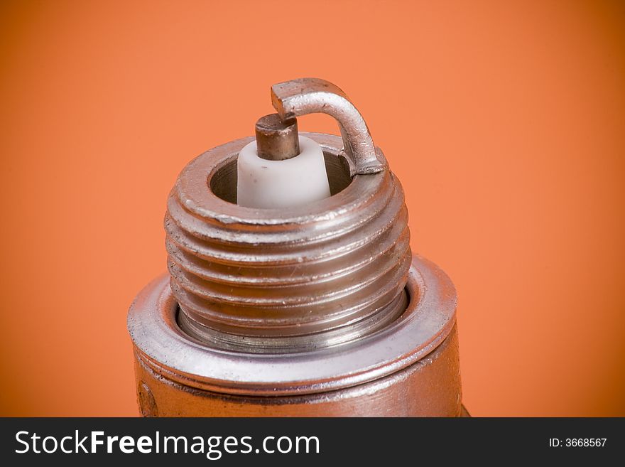 Closeup of the tip of a spark plug. Closeup of the tip of a spark plug.