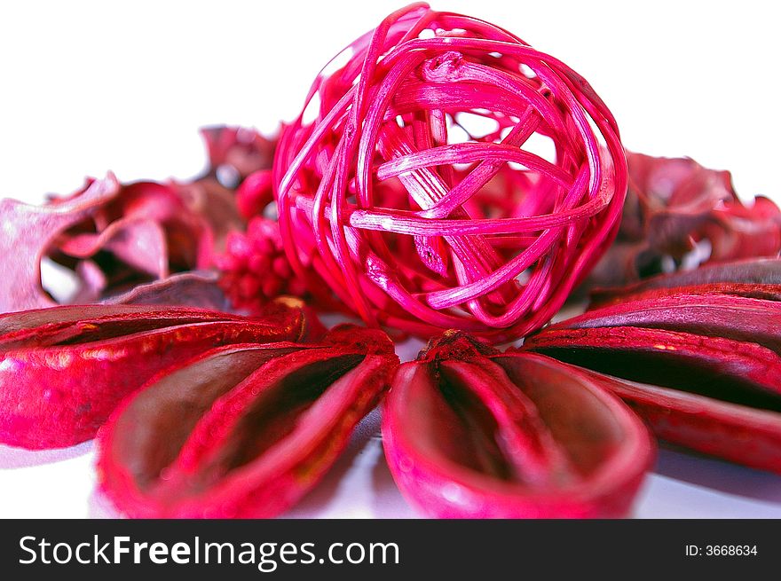 Rattan ball sitting on an arrangement of dried nutshells. Rattan ball sitting on an arrangement of dried nutshells