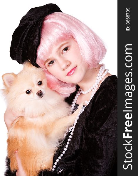 Pretty preteen diva with pink hair snuggling with her Pomeranian puppy. Pretty preteen diva with pink hair snuggling with her Pomeranian puppy.