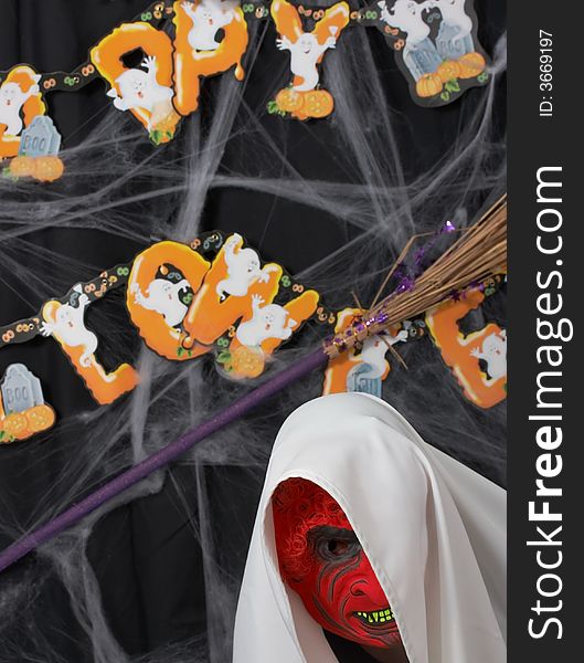 A man wearing a scary mask over a halloween background