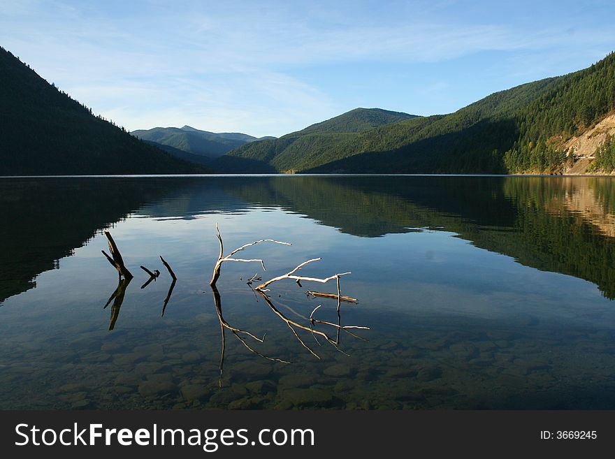 Early morning over a calm mountain lake. Early morning over a calm mountain lake.