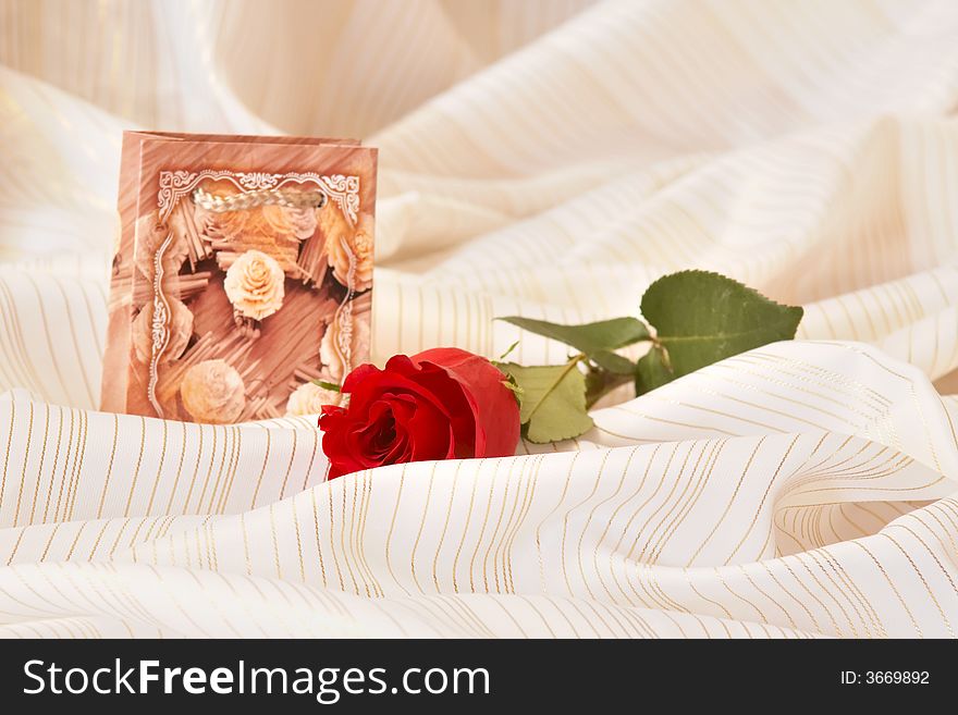 An image of red rose and box