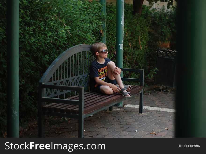 Boy resting on a bench - dreams. Boy resting on a bench - dreams
