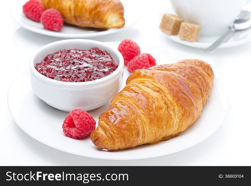 Fresh croissant, raspberry and jam for breakfast