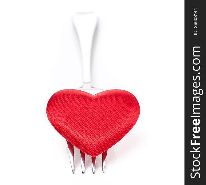 Red heart on a fork, isolated on white