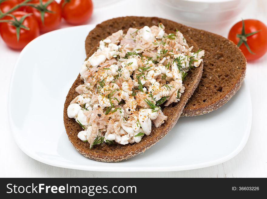 Rye bread with tuna, homemade cheese and dill, close-up