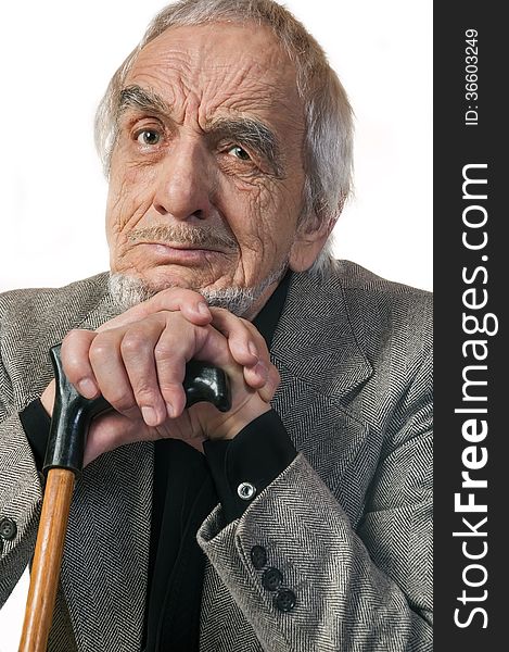 Portrait emotional elderly man leaning on a cane